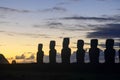 Silhouetted moai statues at twilight sky on Easter Island Royalty Free Stock Photo