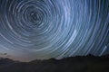 silhouetted mountains with circumpolar star trails in northern sky Royalty Free Stock Photo