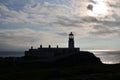 Silhouetted Neist Point Lighthouse at Dusk on the Isle of Skye Royalty Free Stock Photo