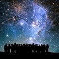 silhouetted people and lights of universe