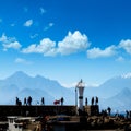 Silhouetted people walking in Antalya harbor