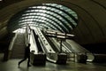 Silhouetted people riding escalators at Canary Wharf Station Royalty Free Stock Photo