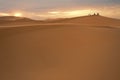 Silhouetted people in Sahara sunset