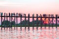 Silhouetted people on U Bein Bridge at sunset, Amarapura, Mandalay region, Myanmar