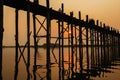 Silhouetted people on U Bein Bridge at sunset, Amarapura, Mandalay region, Myanmar Royalty Free Stock Photo