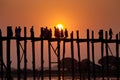 Silhouetted people on U Bein Bridge at sunset, Amarapura, Mandalay region, Myanmar. Burma. The longest and oldest teak Royalty Free Stock Photo