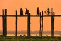 Silhouetted people on U Bein Bridge at sunset, Amarapura, Myanmar