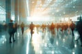 Silhouetted people walking in sunlit convention hall