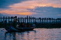 Silhouetted person on U Bein Bridge at sunset, Amarapura, Mandalay region, Myanmar