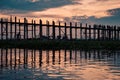 Silhouetted person on U Bein Bridge at sunset, Amarapura, Mandalay region, Myanmar