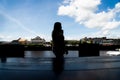 A silhouetted person walking along the edge of the tourist town of Valenca