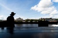 A silhouetted person walking along the edge of the tourist town of Valenca