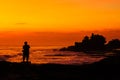 Silhouetted of photographer and Tanah Lot at sunset, Bali, Indonesia. Royalty Free Stock Photo