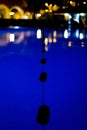 Silhouetted pool divider buoy floaters=at night