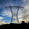 Silhouetted power line against a vast cloudy sky