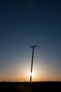 Silhouetted Power Pole On Canadian Prairie At Sunrise Vertical C