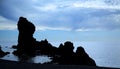 Silhouetted rocks on Dritvik beach Royalty Free Stock Photo