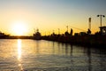 Silhouetted shot of a people fishing on pier at sunset Royalty Free Stock Photo