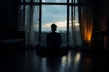 Silhouetted solitude man alone, staring at closed curtains in bedroom