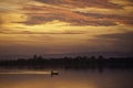 Silhouetted traditional wooden canoes fishing in Asia