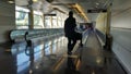 Silhouetted traveler at an airport automated walkway