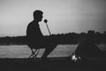 Silhouetted, unrecognizable person by the bonfire at night camping