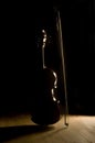 Silhouetted violin and bow Royalty Free Stock Photo