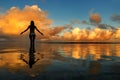 Silhouetted woman standing in a water at sunset on Taveuni Island, Fij Royalty Free Stock Photo