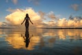 Silhouetted woman standing in a water at sunset on Taveuni Island, Fij Royalty Free Stock Photo