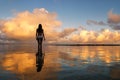 Silhouetted woman standing in a water at sunset on Taveuni Island, Fij Royalty Free Stock Photo