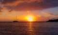Silhouetted Yacht Against Tropical Setting Sun Royalty Free Stock Photo