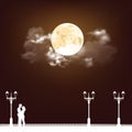 Silhouetted young lovers with full moon