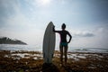 Silhouetted young woman surfer girl with white surfboard Royalty Free Stock Photo