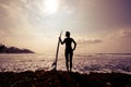 Silhouetted young woman surfer girl with white surfboard Royalty Free Stock Photo