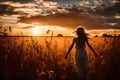 Silhouetted Young Woman Walks Into Beautiful Sunset Royalty Free Stock Photo