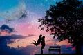 SilhouettedCouple are under big tree withold bench Royalty Free Stock Photo