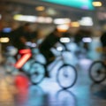 Silhouettes of abstract unrecognizable people, riding bikes, night city, illumination bokeh, motion blur. Healthy Royalty Free Stock Photo