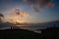 Silhouettes of Ahu Tahai moai in Hanga Roa, Easter Island during sunset