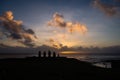 Silhouettes of Ahu Tahai moai in Hanga Roa, Easter Island during sunset