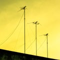 Silhouettes of antennas with sunset