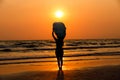 silhouettes of beautiful sexy young women surfer girls in bikinis with surfboards on a beach at sunset in sea, sport activity and Royalty Free Stock Photo