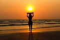 silhouettes of beautiful sexy young women surfer girls in bikinis with surfboards on a beach at sunset in sea, sport activity and Royalty Free Stock Photo