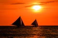 Silhouettes of boats against a red sunset sky Royalty Free Stock Photo