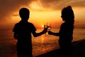 Silhouettes of boy and girl with glasses on sunset Royalty Free Stock Photo