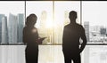 Silhouettes of business partners over city office Royalty Free Stock Photo