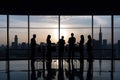 Silhouettes of business people in blurred meeting room. Business teamwork concept. Group of Business People Working in Royalty Free Stock Photo