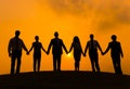 Silhouettes Of Business People Holding Hands Outdoors