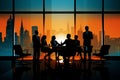 Silhouettes of business people in a meeting room at sunset.