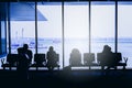 Silhouettes of business people traveling on airport; waiting at the plane boarding gates Royalty Free Stock Photo
