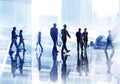 Silhouettes of Business People Wallking Inside the Office Royalty Free Stock Photo